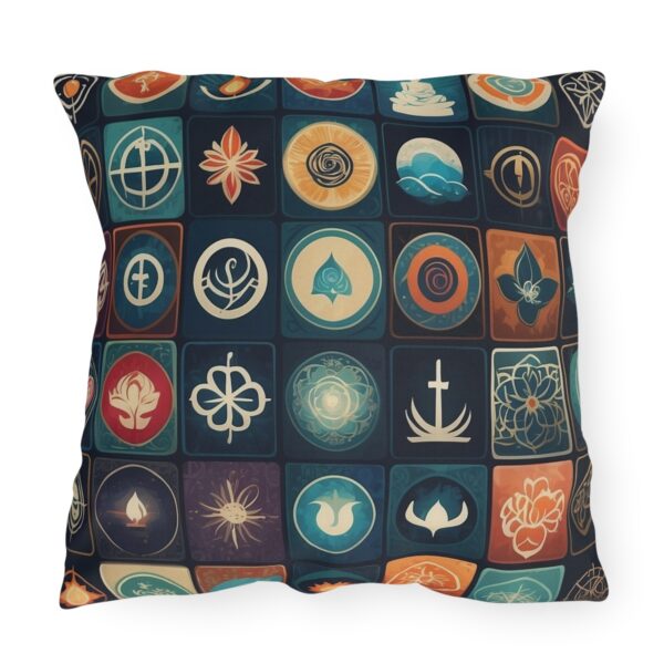 Outdoor pillow with a design featuring various spiritual icons in a colorful grid pattern on a dark background.