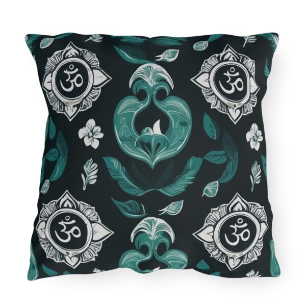 Outdoor pillow with a design featuring the sacred Om symbol and intricate teal floral patterns on a dark background.