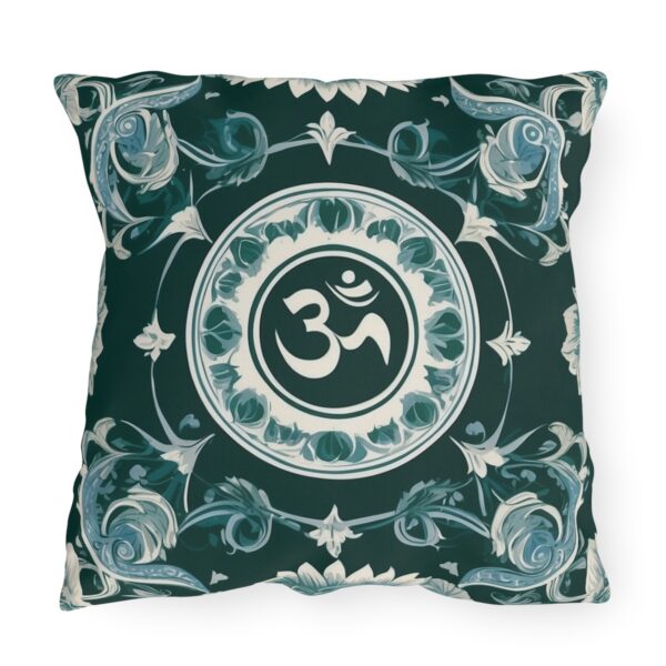 Outdoor pillow with a design featuring the sacred Om symbol in white on a dark green background with intricate floral patterns.