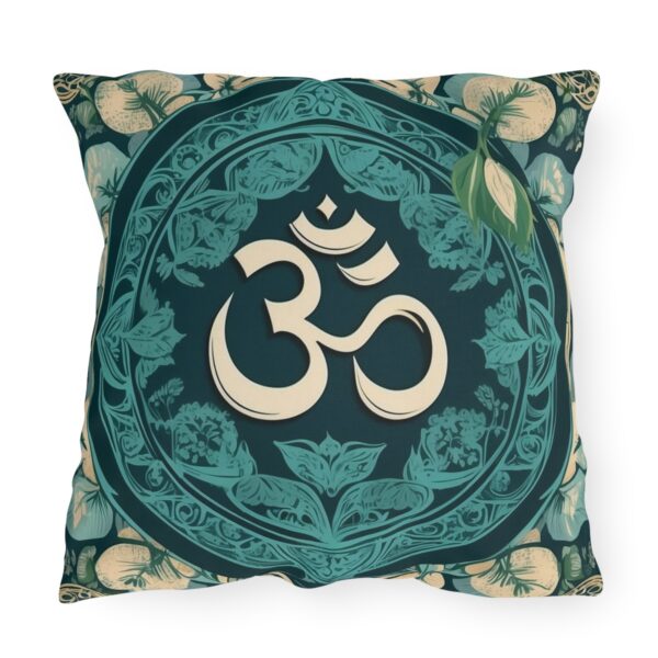 Outdoor pillow with a design featuring the sacred Om symbol in beige on a dark teal background with intricate floral patterns.