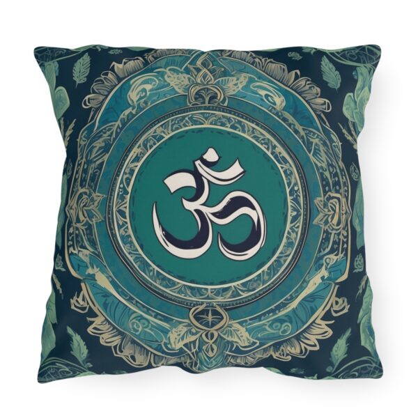 Outdoor pillow with a design featuring the sacred Om symbol in white on a teal and dark background with intricate patterns.