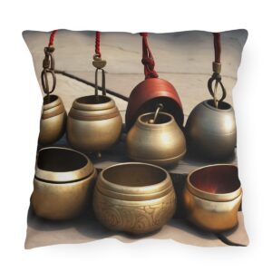 Outdoor pillow with a design featuring hanging and resting meditation bells.