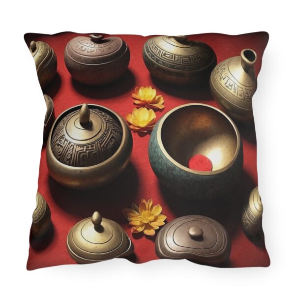 Outdoor pillow with a design featuring multiple meditation bells and flowers on a red background.