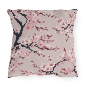 Outdoor pillow with pink cherry blossoms on a light beige background.