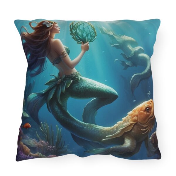 Outdoor pillow featuring an underwater scene with a mermaid holding seaweed and a large fish