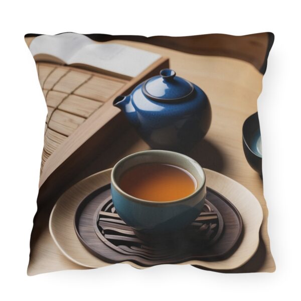 Outdoor pillow featuring a traditional tea ceremony setup with a blue teapot, teacup, and wooden tray