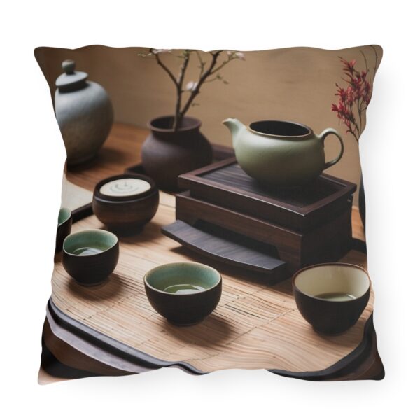 Outdoor pillow featuring a traditional tea ceremony setup with a green teapot, cups, and wooden trays