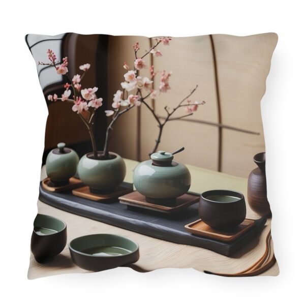 Outdoor pillow featuring a traditional tea ceremony setup with green teapots, cups, and cherry blossoms on a tray