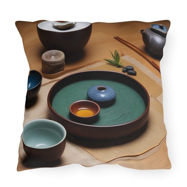 Outdoor pillow featuring a traditional tea ceremony setup with cups, a teapot, and a tray on a wooden table