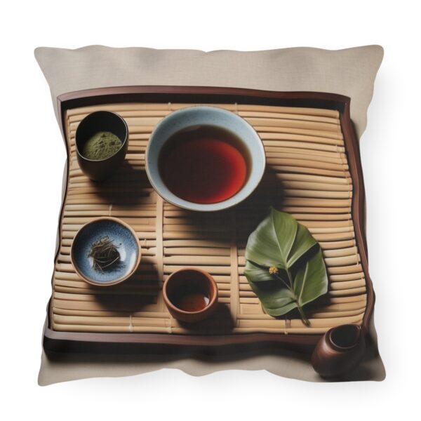 Outdoor pillow featuring a traditional tea ceremony setup with cups, tea leaves, and a bamboo mat