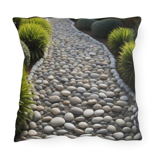 Outdoor pillow featuring a Zen pebble path with numerous smooth stones and surrounded by greenery