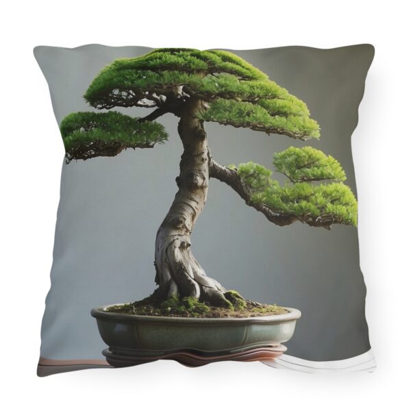 Outdoor pillow featuring a detailed bonsai tree in a pot against a gray background