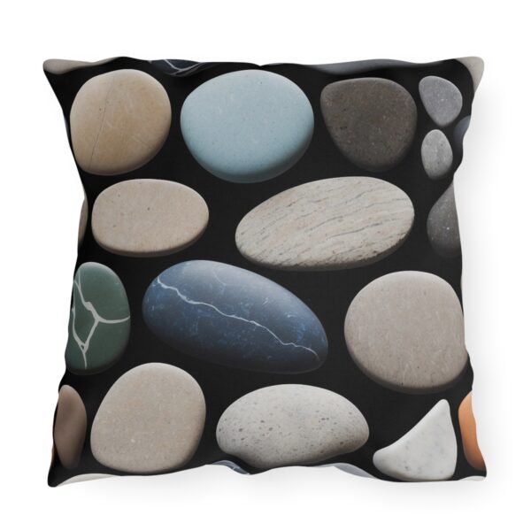 Outdoor pillow with a design of various smooth stones in different colors and sizes