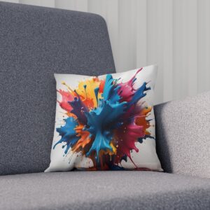 Cushion with a burst of paint splatters on gray chair