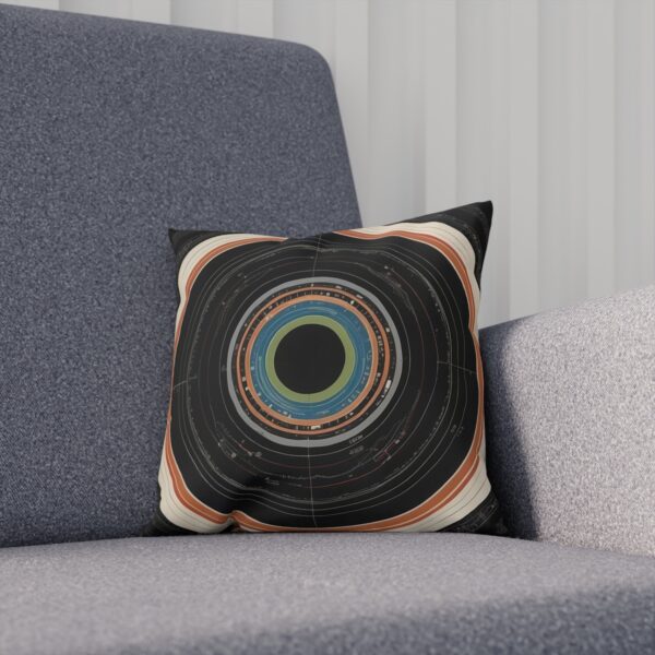 Dark cushion with concentric circle design on gray chair