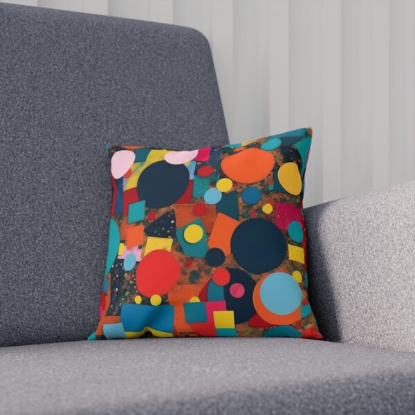 Cushion with colorful circles and squares on gray chair