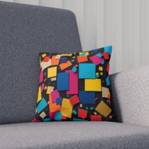 Cushion with abstract colorful shapes on modern gray chair