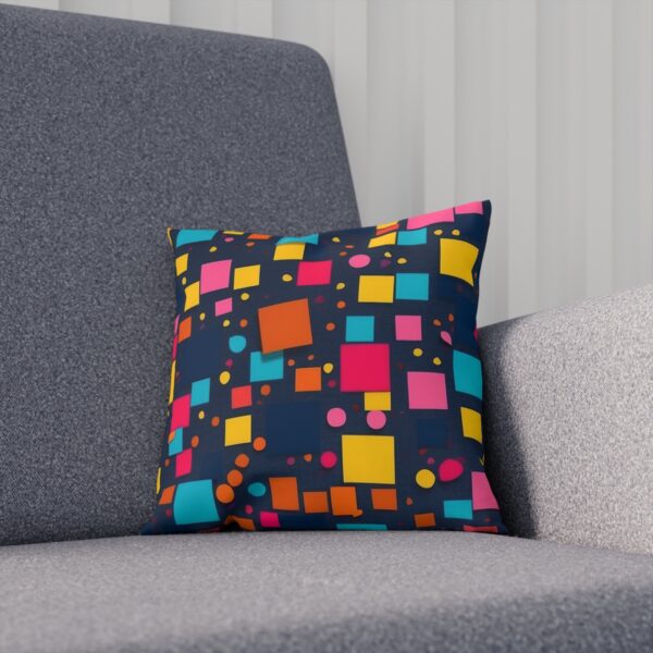 Cushion with colorful blocks and dots pattern on a gray chair