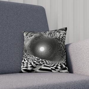 Black and white op art cushion with a central light orb effect on a grey couch.