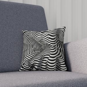 Wavy black and white op art cushion with a central spiral on a grey sofa.