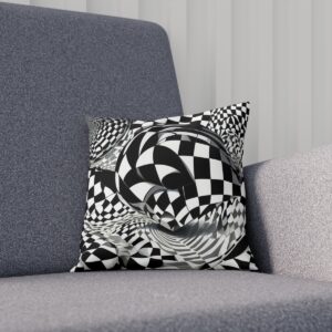 Black and white op art cushion with a spherical twist design on a grey couch.