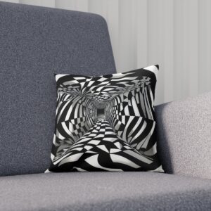 Black and white op art vortex cushion on a gray sofa.