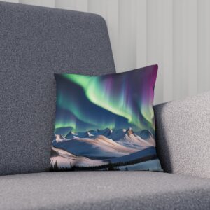 Cushion with an abstract aurora borealis design above snowy mountains on a sofa