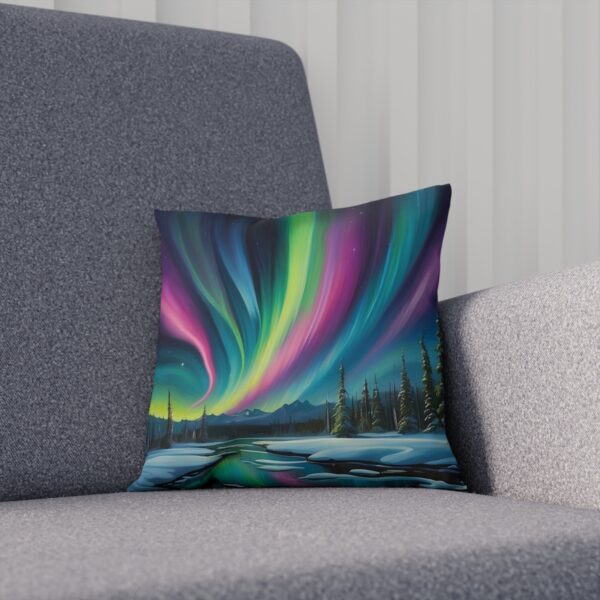 Aurora-themed cushion with vibrant colors on a grey sofa