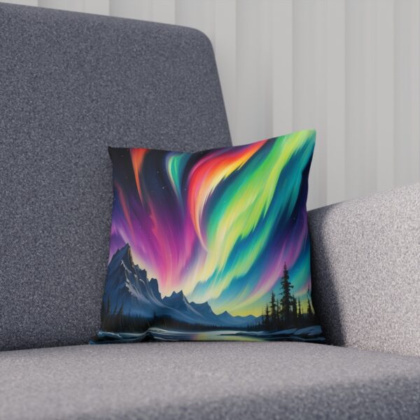 Cushion with abstract aurora design on a gray couch