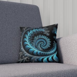 Cushion with dark teal fractal spiral on a black background on a sofa.