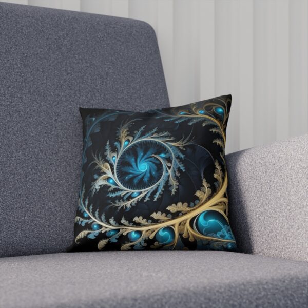 Decorative cushion with dark teal fractal design and golden highlights on a sofa.