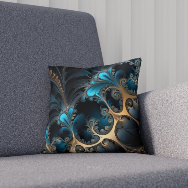 Cushion with blue and gold fractal design on a dark background on a sofa.