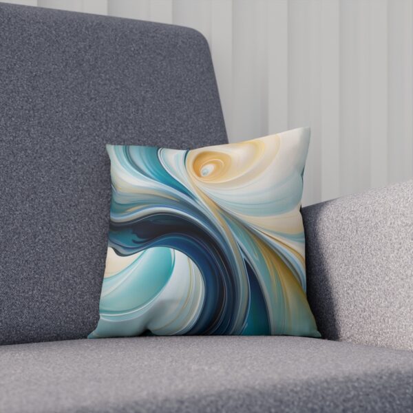 Cushion with creamy swirls and blue accents creating an abstract design on a couch.