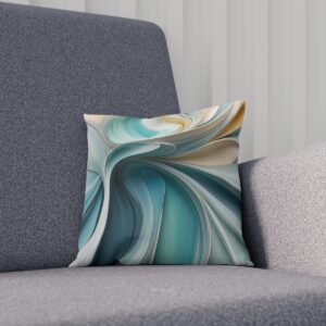 Abstract fluid art cushion in cool tones of teal and cream on a gray sofa.