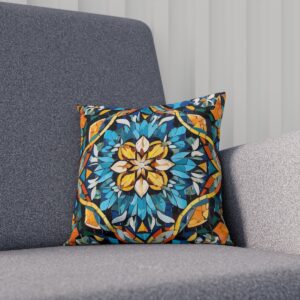 Cushion with a blue, gold, and teal mosaic floral design on a grey sofa.