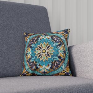 Cushion with intricate teal and gold mosaic mandala design on a sofa.