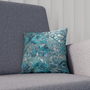 Teal mosaic pattern cushion adding a cool-toned texture to a grey couch.