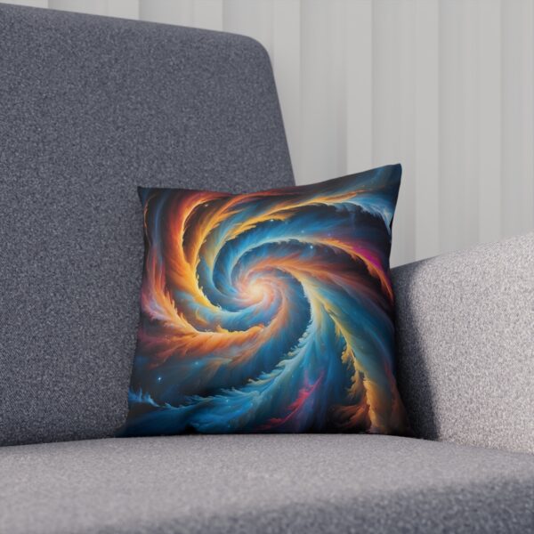 Cushion with a cosmic swirl pattern in shades of blue and orange on a sofa.