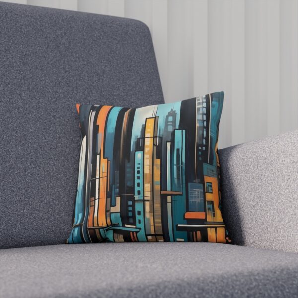 Cushion with modern urban skyline in blue and orange tones on a gray couch.