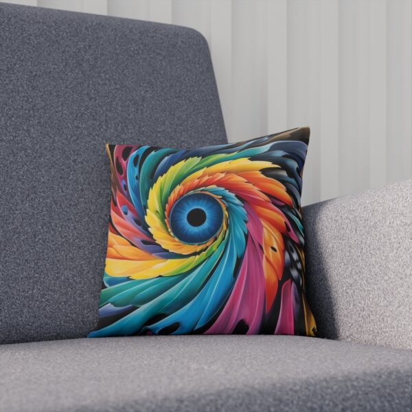 Vibrant multicolored spiral pattern cushion on a gray sofa.