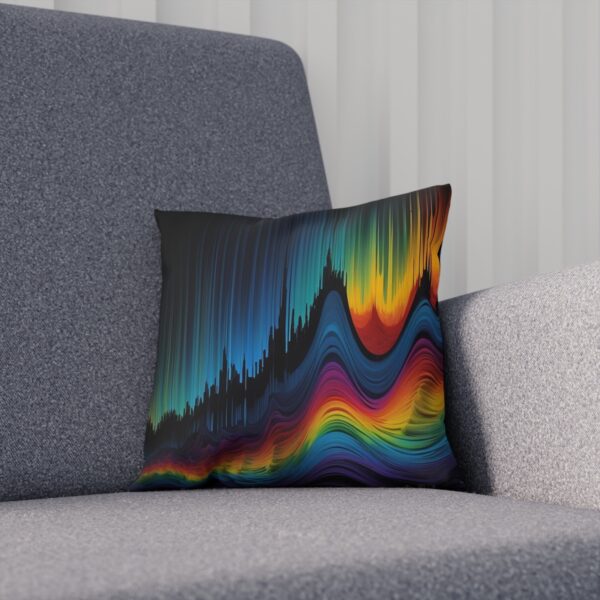 Cushion with a multicolored waveform pattern on a gray couch.