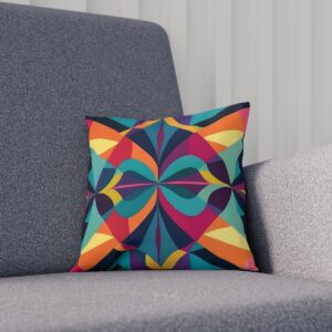 Cushion with a kaleidoscopic geometric pattern on a gray couch.