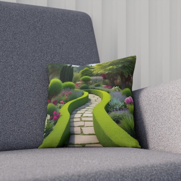 Cushion with a curving garden path and lush foliage on a grey sofa.