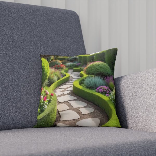 Cushion with a garden path design on a gray couch.