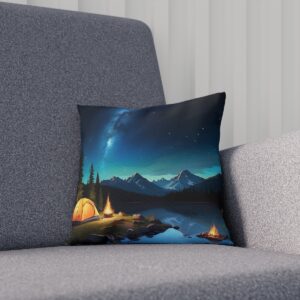 Cushion with a nocturnal mountain camping scene under a starry sky on a sofa.