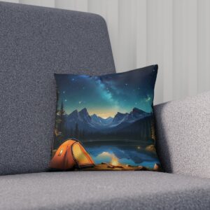 Cushion with a starry sky over a mountain campsite on a sofa.