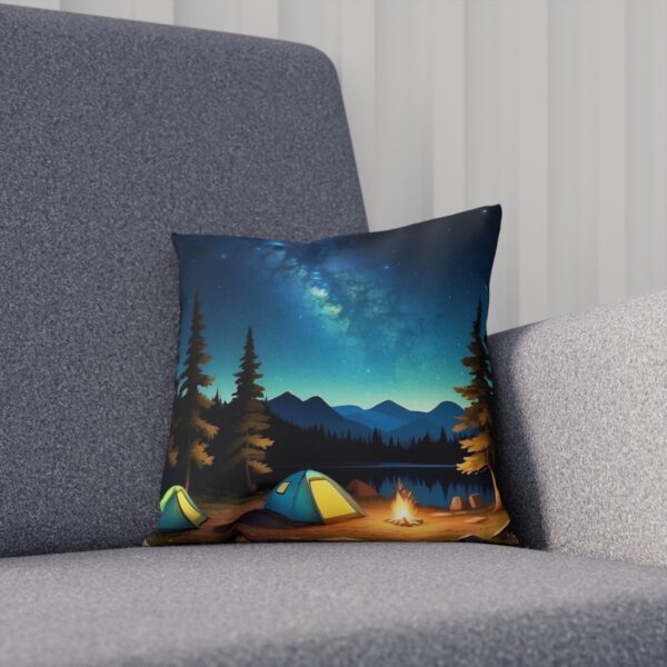 Cushion with night camping scene and aurora sky on a couch.