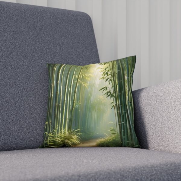 Cushion with bamboo grove and sunlight design on a gray couch.