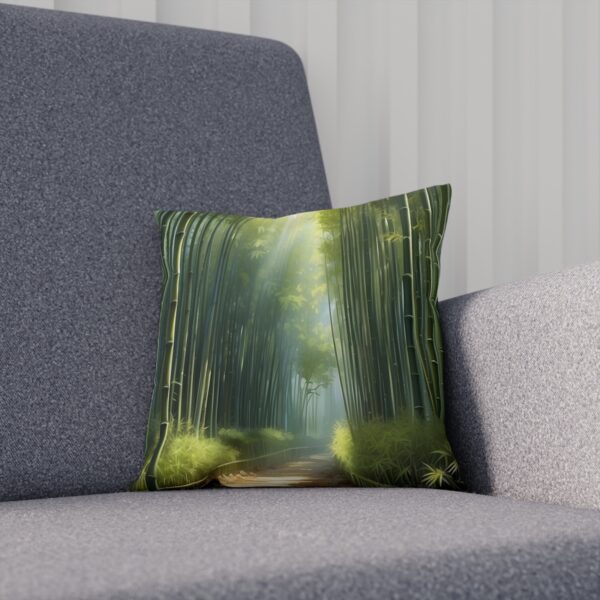 Cushion with a bamboo forest print on a gray couch.