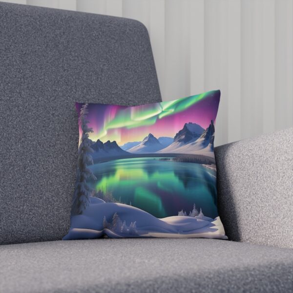 Cushion featuring Northern Lights over snowy mountains and forest on a grey couch